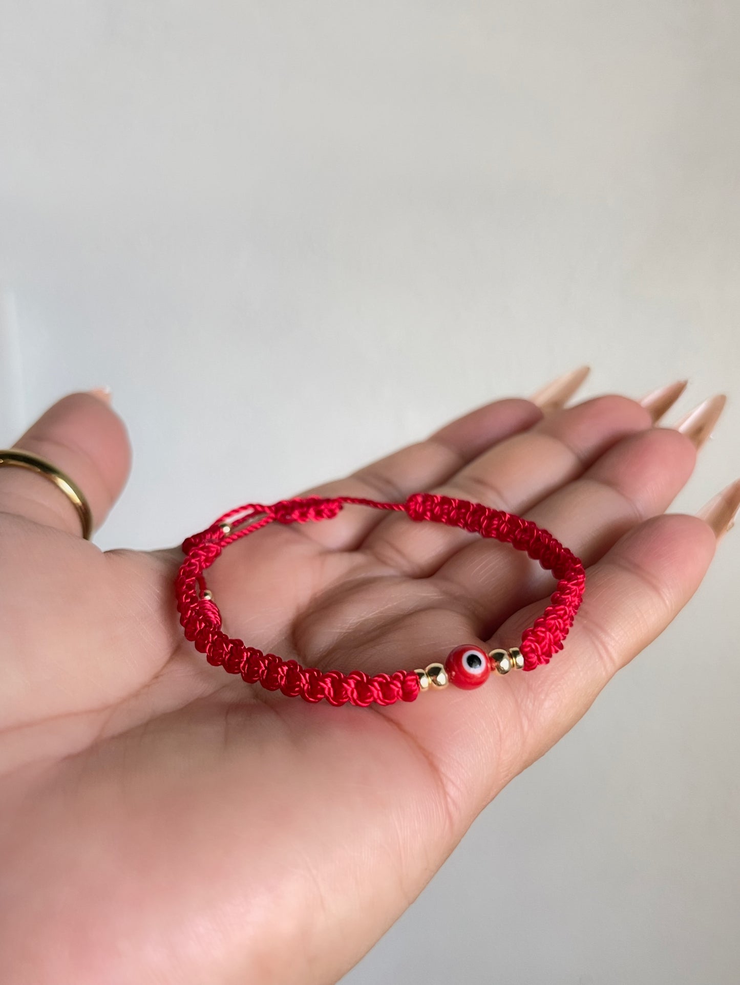 Red braided ojito bracelet